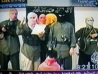 Hassim (second from left) works a night shift for the Brotherhood Of Total Islamic War.